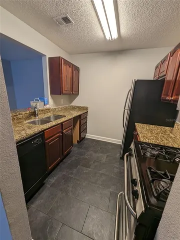 a kitchen with a stove and a refrigerator