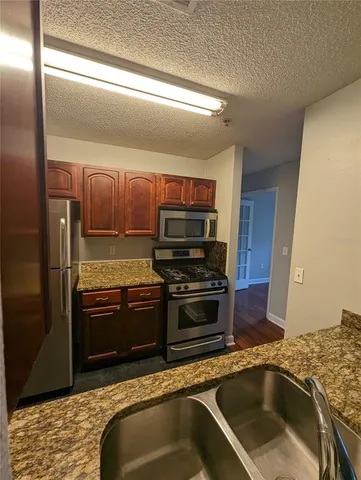 a kitchen with a stove microwave and refrigerator