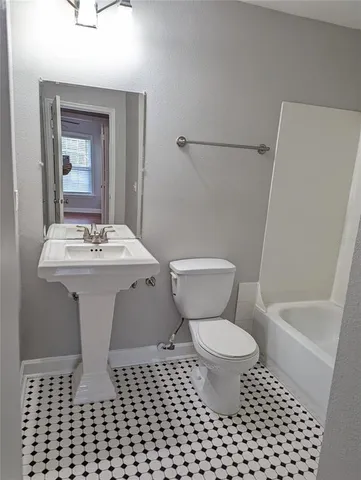 a bathroom with a sink toilet mirror and shower