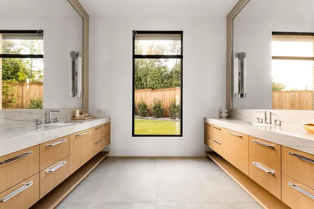 a bathroom with a granite countertop sink mirror and a bathtub