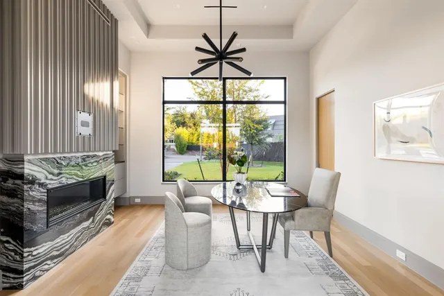 a dining room with furniture a flat screen tv and a large window