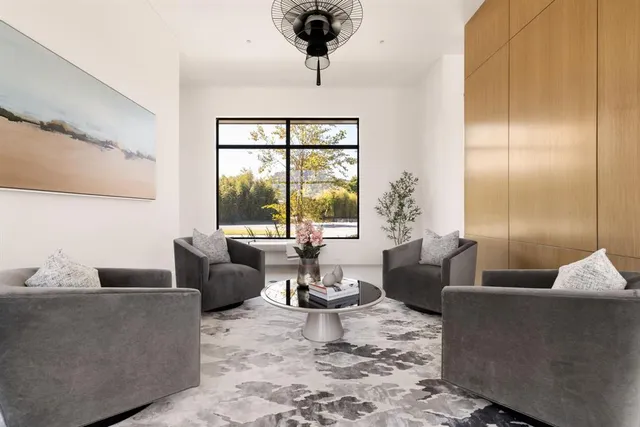 a living room with furniture and large windows