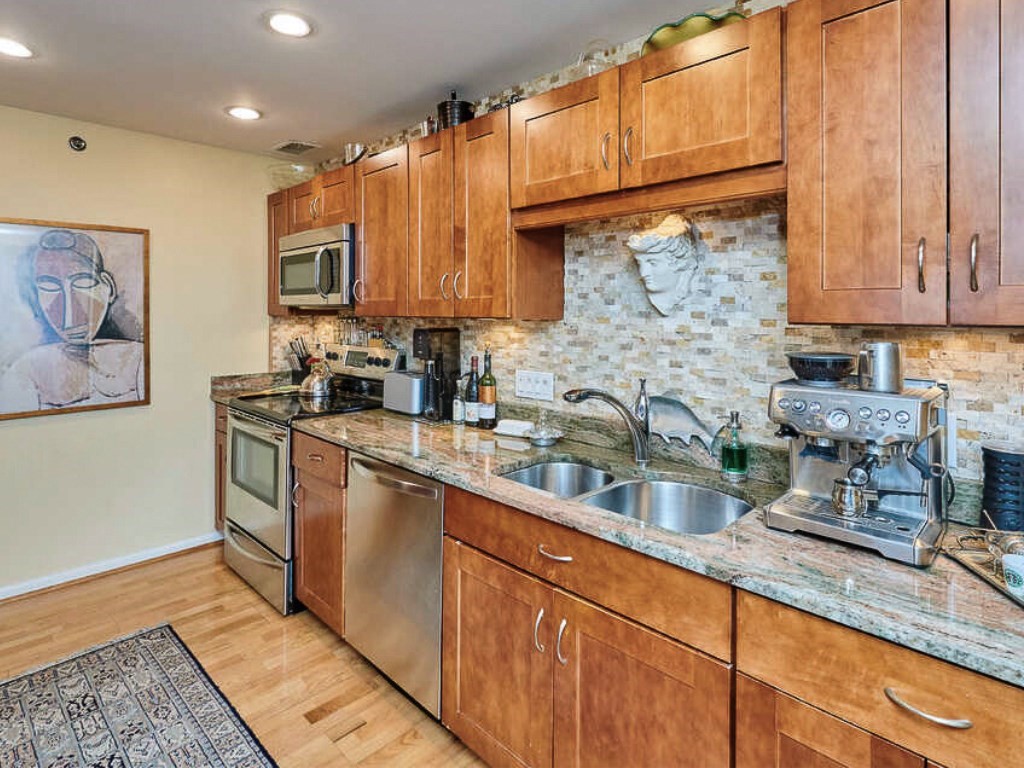 3 Seal Harbor Road, Unit 744 Winthrop, MA 02152 - Photo 7 of 30 a kitchen with stainless steel appliances granite countertop a sink stove and cabinets