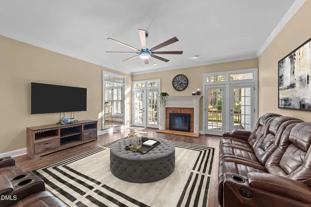 a living room with furniture a fireplace and a flat screen tv
