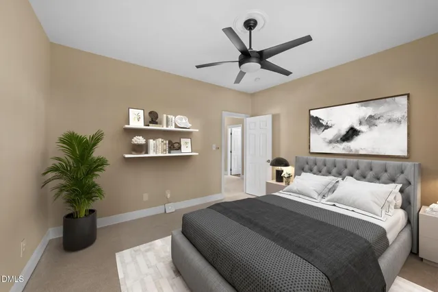 a bedroom with a large bed and a potted plant