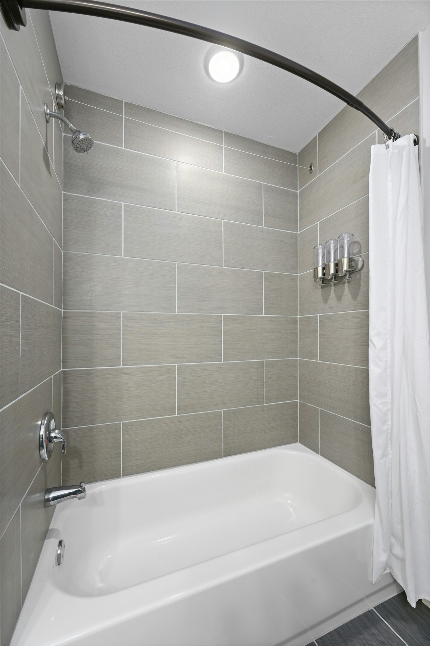 909 Reinli Street, Unit 228 Austin, TX 78751 - Photo 17 of 27 a bathroom with a bathtub and a shower