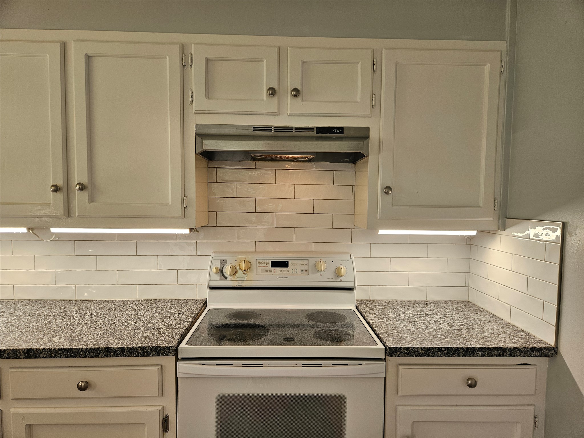 806 Ranch Road, Unit A Georgetown, TX 78628 - Photo 7 of 24 White subway tile backsplash complements a granite countertop in this well-appointed cooking space.