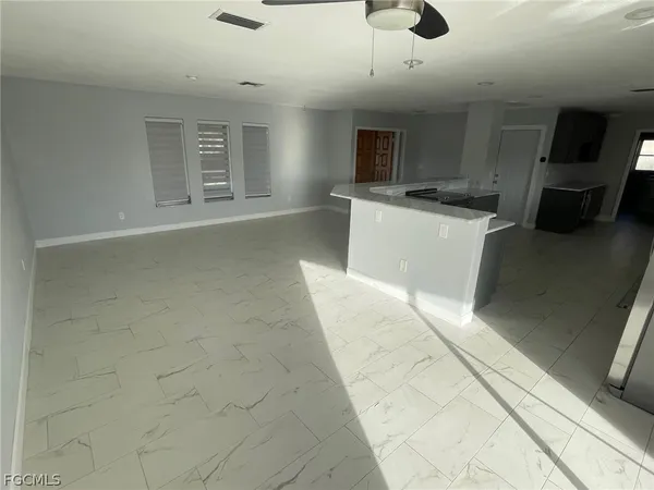 a view of a kitchen with microwave and cabinets