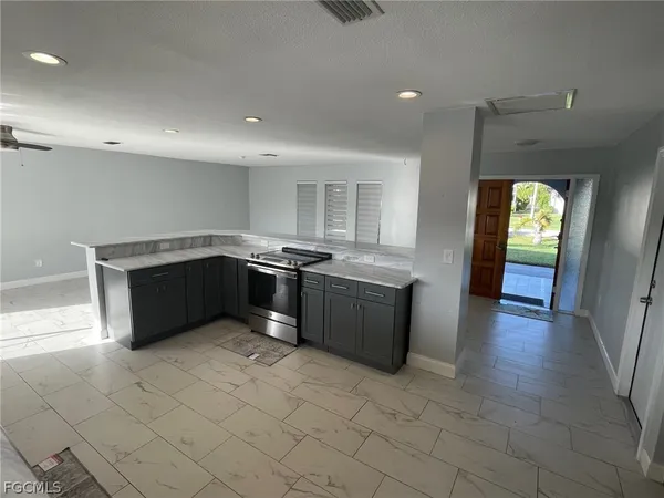 a kitchen with stainless steel appliances granite countertop a sink and cabinets
