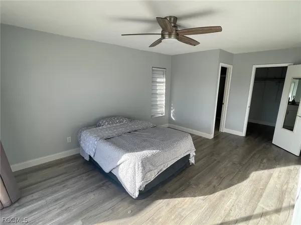 a bedroom with a bed and a large mirror