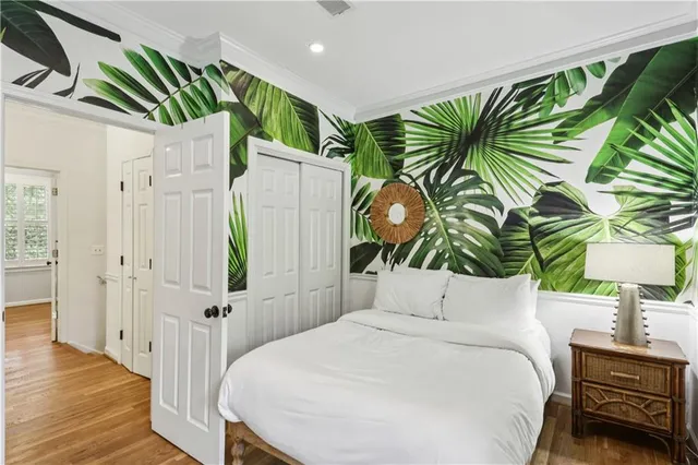 a bedroom with a bed and a painting on the wall