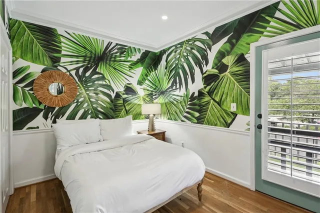 a bedroom with a bed and a painting on the wall