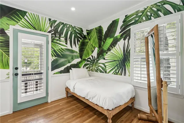 a bedroom with a bed and a large window