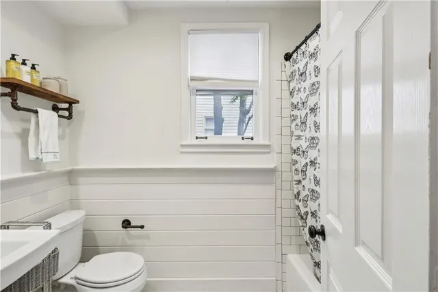 a bathroom with a toilet and a shower