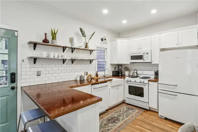 a kitchen with a stove a sink and a refrigerator