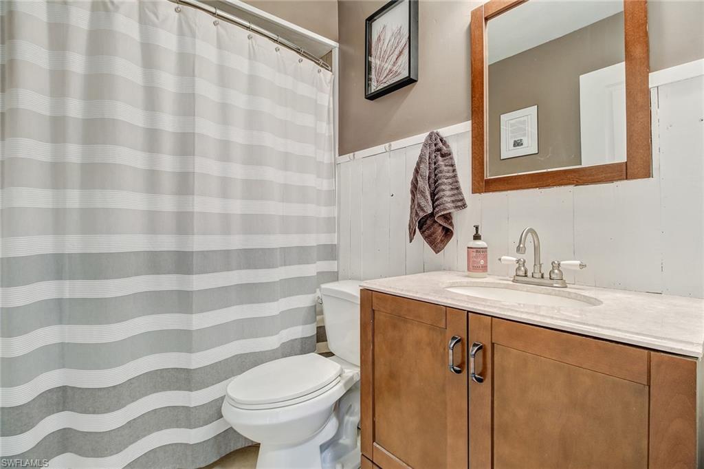 17405 Lebanon Road Fort Myers, FL 33967 - Photo 18 of 26 Guest Bath with shower/tub combo and shiplap
