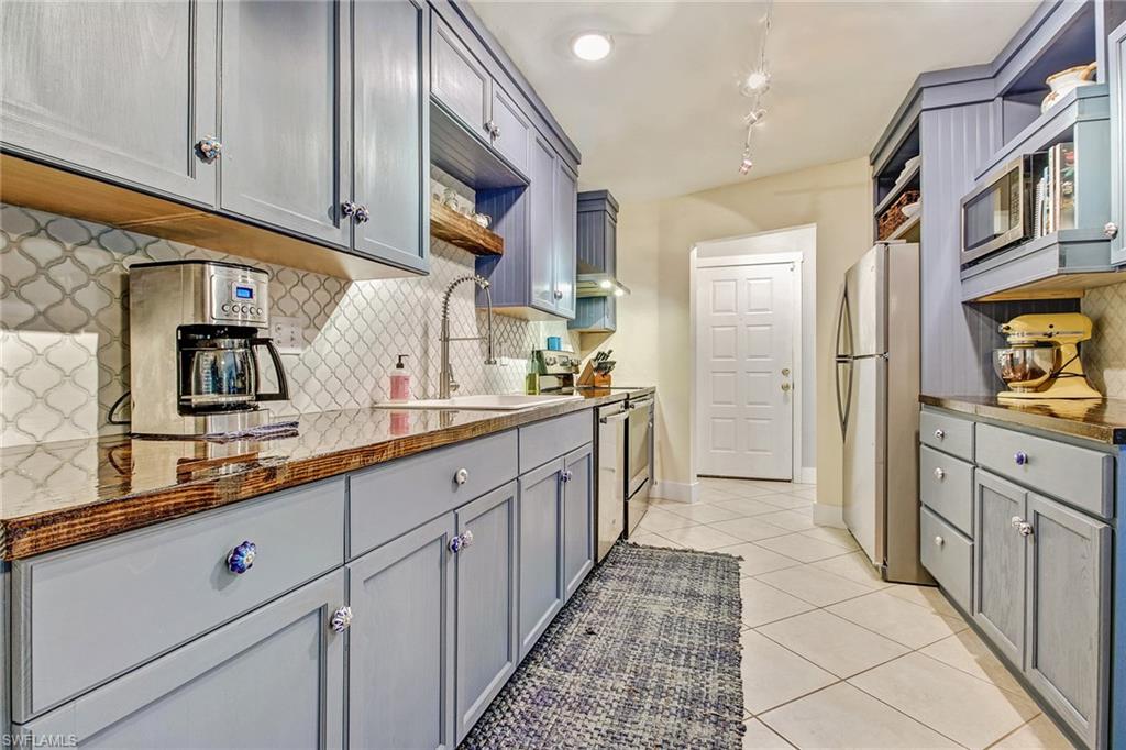 17405 Lebanon Road Fort Myers, FL 33967 - Photo 2 of 26 White backsplash and finished reclaimed wood counters
