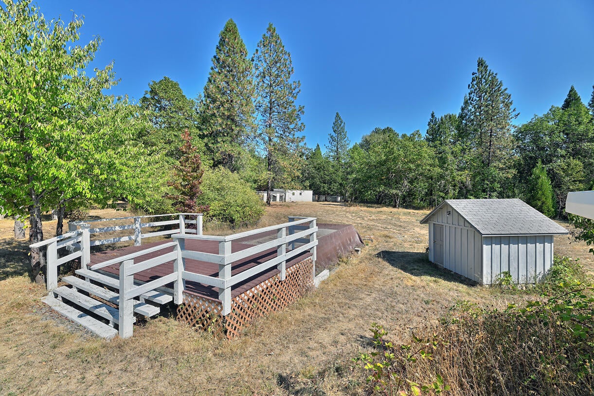 1040 Garner Road Cave Junction, OR 97523 - Photo 37 of 50 Backyard with deck, pool and pump house