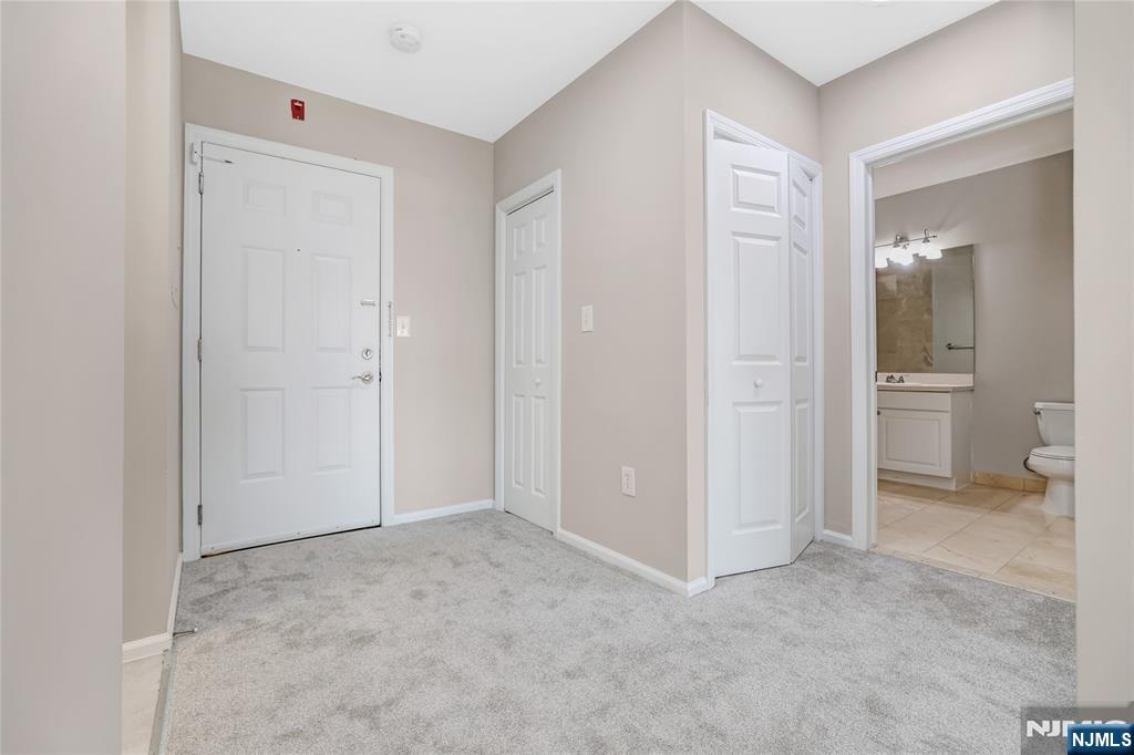 905 River Road, Unit 309 Edgewater, NJ 07020 - Photo 7 of 32 an empty room with a bathroom and sink