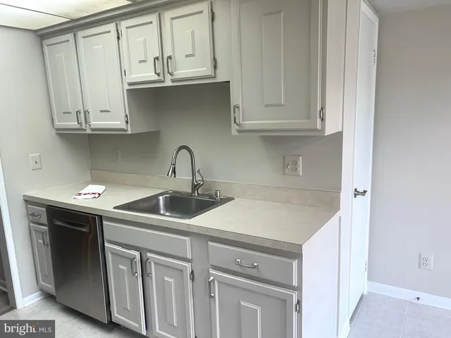 a kitchen with a sink and cabinets