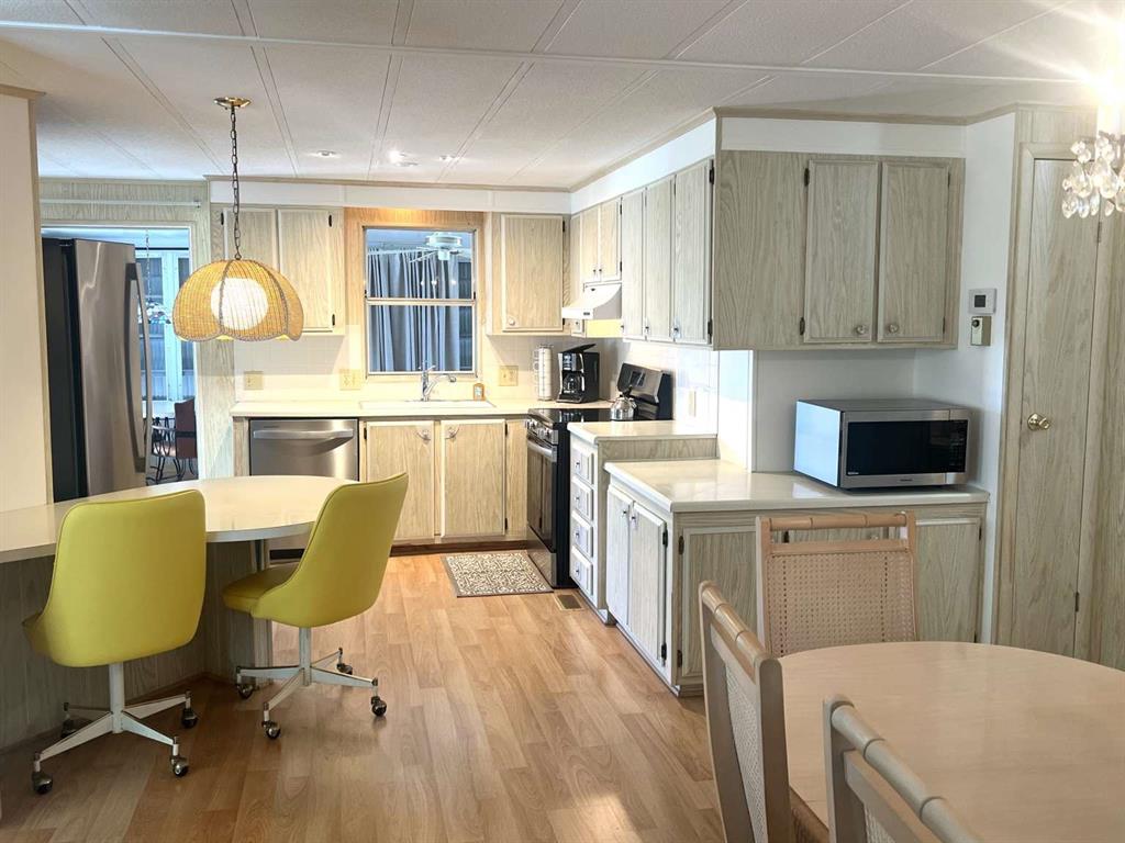 4266 Bob White Drive Boynton Beach, FL 33436 - Photo 11 of 24 a kitchen with a sink cabinets and wooden floor