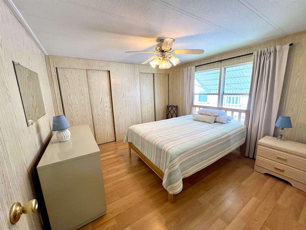 4266 Bob White Drive Boynton Beach, FL 33436 - Photo 15 of 24 a bedroom with a bed and a chandelier