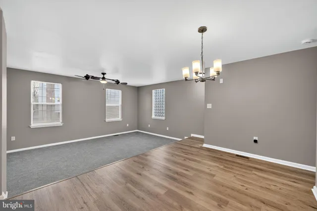 a view of a room with wooden floor and window