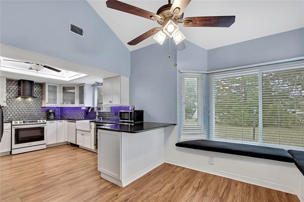 46 Greentree Street Homosassa, FL 34446 - Photo 11 of 49 a kitchen with stainless steel appliances a stove top oven and a chandelier