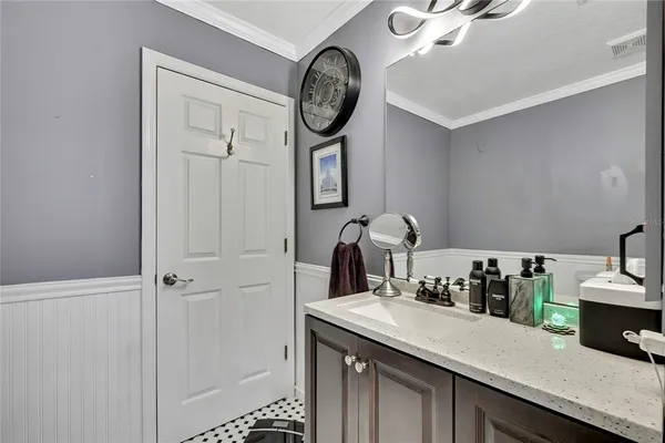 a kitchen with a sink and a clock on the wall
