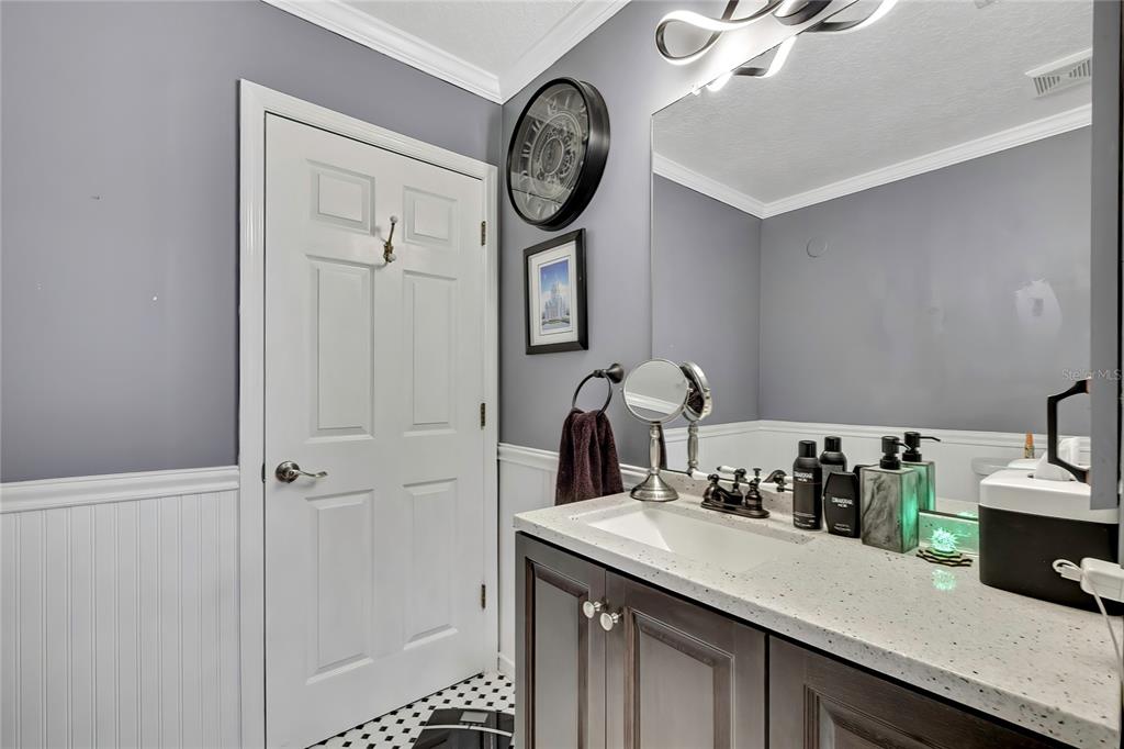 46 Greentree Street Homosassa, FL 34446 - Photo 13 of 49 a kitchen with a sink and a clock on the wall