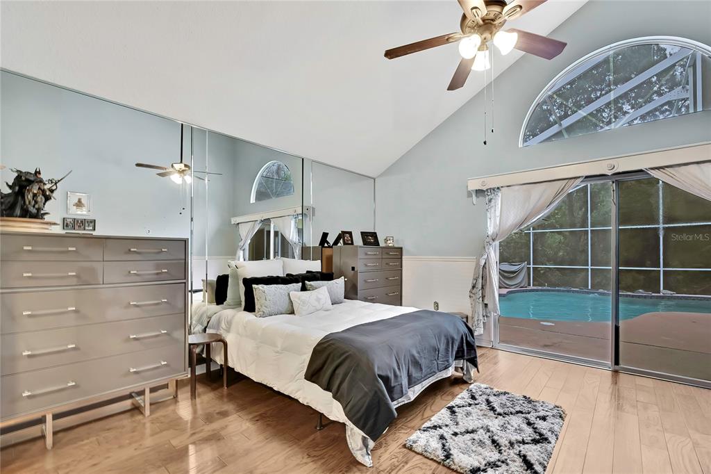 46 Greentree Street Homosassa, FL 34446 - Photo 14 of 49 a spacious bedroom with a bed and a mirror