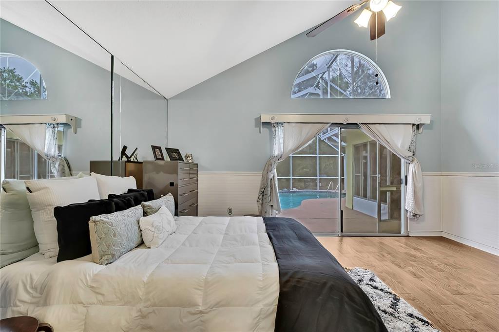 46 Greentree Street Homosassa, FL 34446 - Photo 16 of 49 a bedroom with a bed and a chandelier