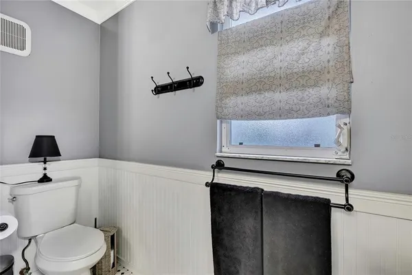 a bathroom with a toilet a sink and a mirror