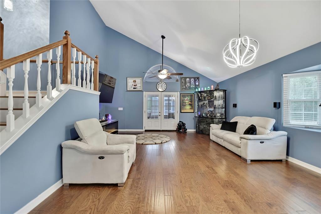 46 Greentree Street Homosassa, FL 34446 - Photo 2 of 49 a living room with furniture chandelier and a wooden floor