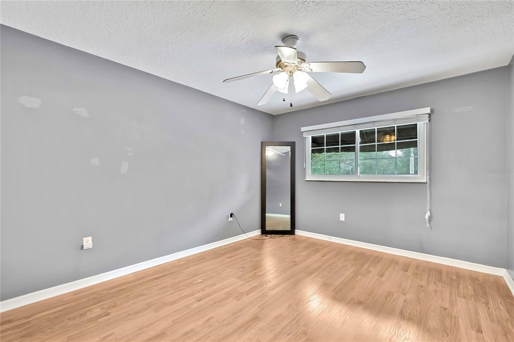46 Greentree Street Homosassa, FL 34446 - Photo 21 of 49 a view of an empty room with wooden floor and a window