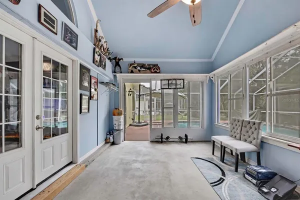a living room with furniture a chandelier and a rug