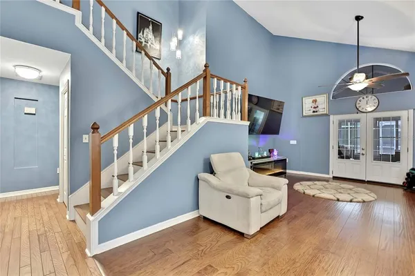 a living room with furniture and a chandelier