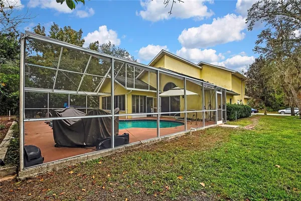 a view of a house with backyard and sitting area