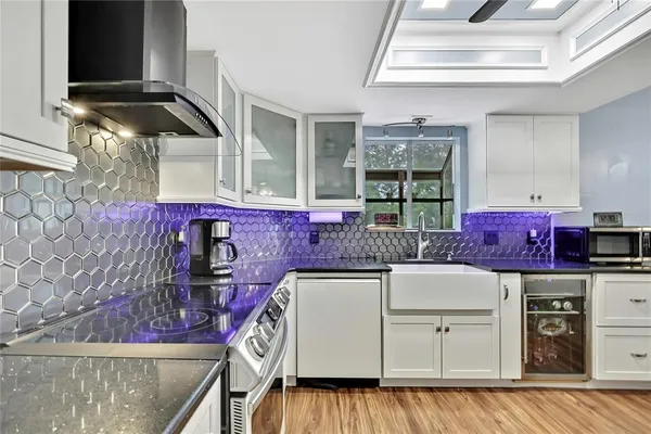 a kitchen with stainless steel appliances granite countertop a sink and cabinets