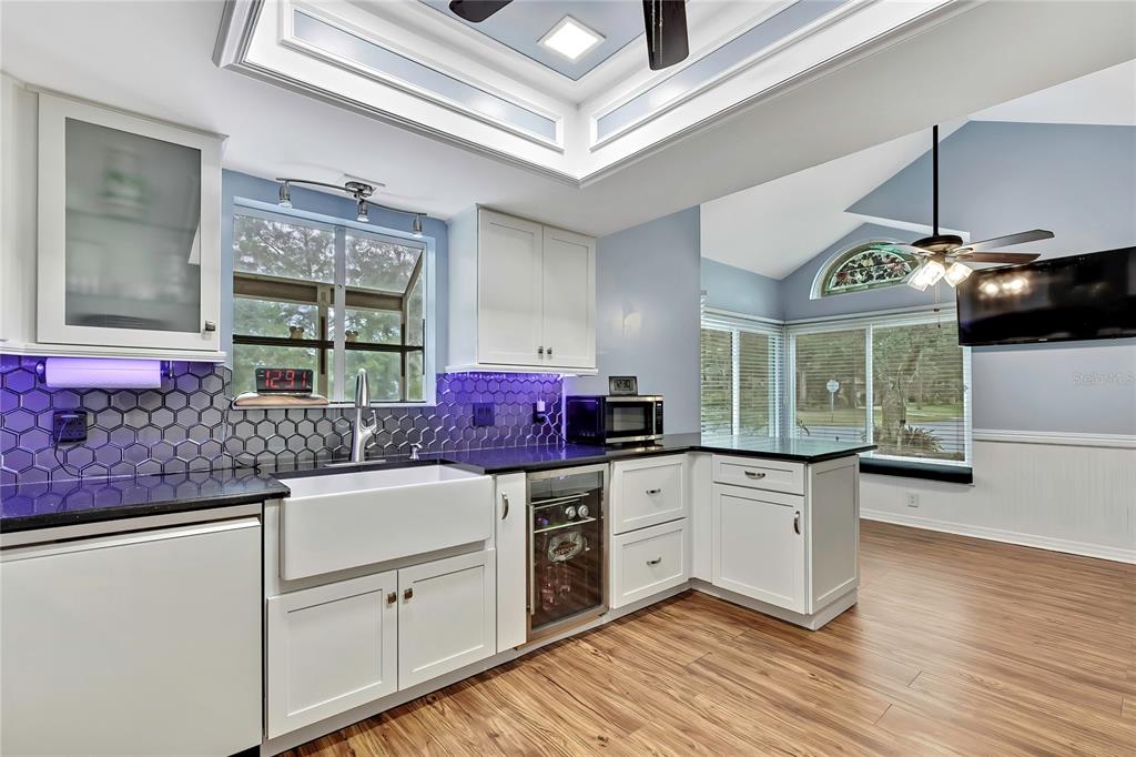 46 Greentree Street Homosassa, FL 34446 - Photo 7 of 49 a kitchen with granite countertop a stove a sink and dishwasher with wooden floor