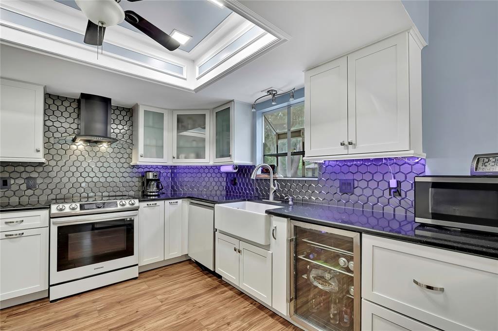 46 Greentree Street Homosassa, FL 34446 - Photo 8 of 49 a kitchen with granite countertop stainless steel appliances a stove microwave and cabinets