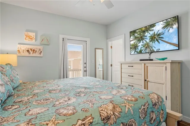 a bedroom with a bed and a lamp on dresser