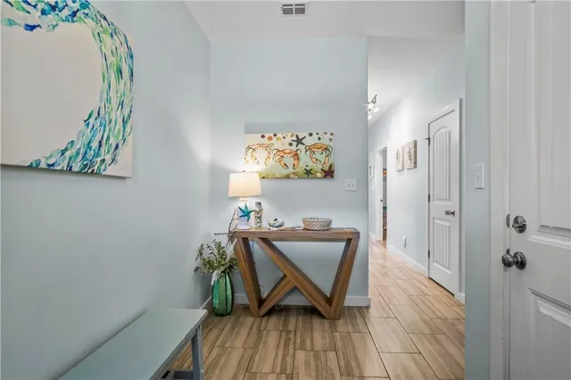 a view of a workspace with furniture and wooden floor