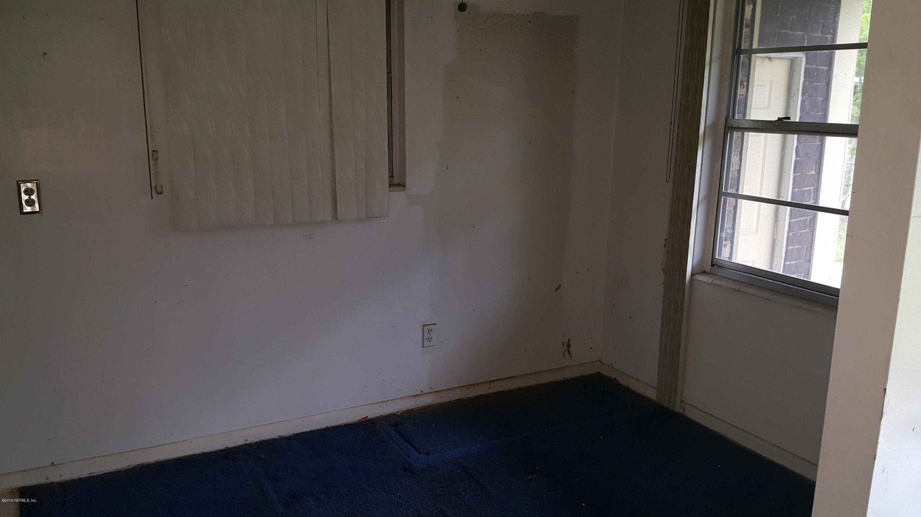 3322 Nancy Street Jacksonville, FL 32209 - Photo 3 of 13 a view of an empty room with a window
