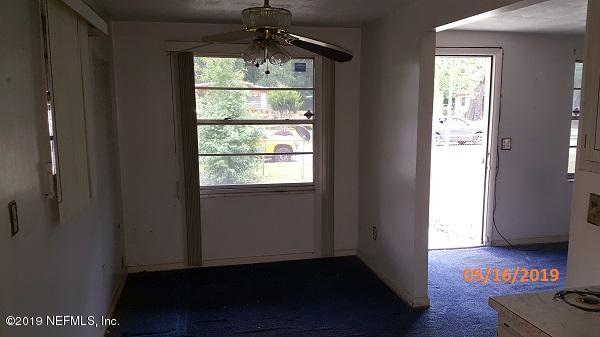 3322 Nancy Street Jacksonville, FL 32209 - Photo 5 of 13 a view of an empty room with wooden floor and a window