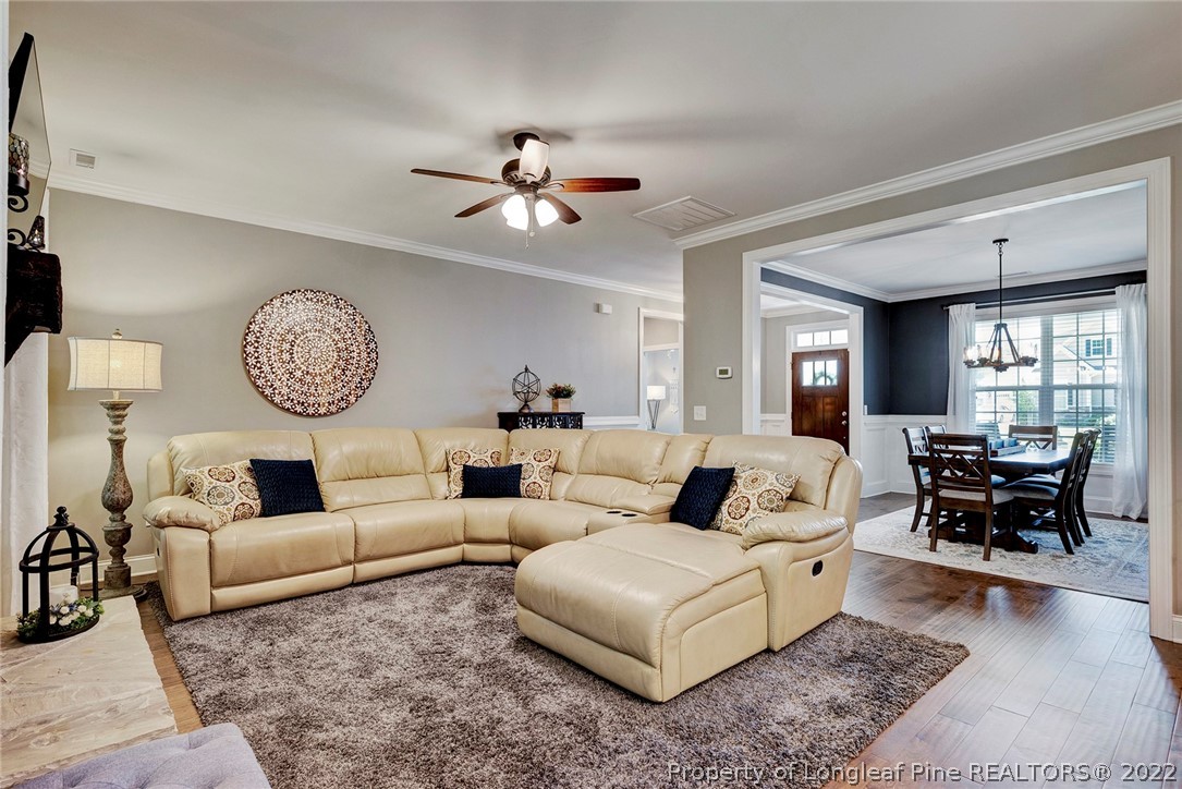 4139 Olde Judd Drive Willow Spring, NC 27592 - Photo 11 of 42 a living room with furniture a clock and a large window