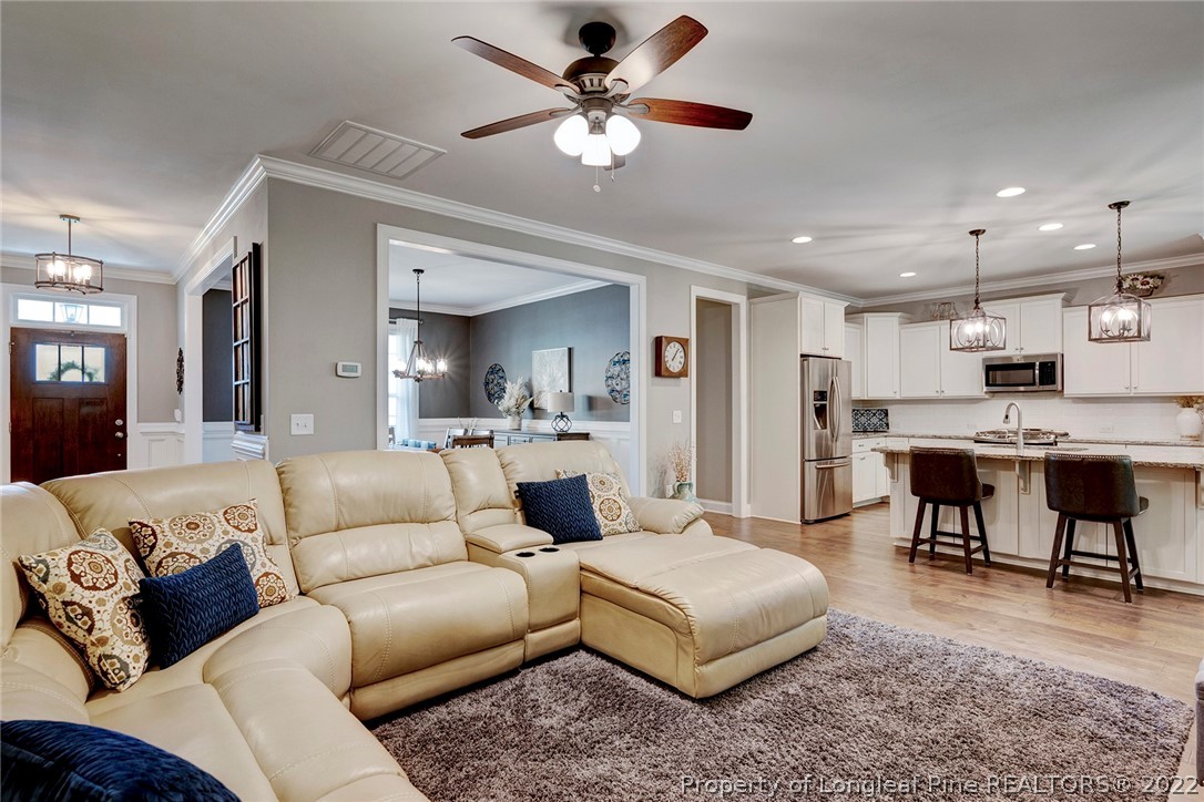4139 Olde Judd Drive Willow Spring, NC 27592 - Photo 12 of 42 a living room with furniture and kitchen view