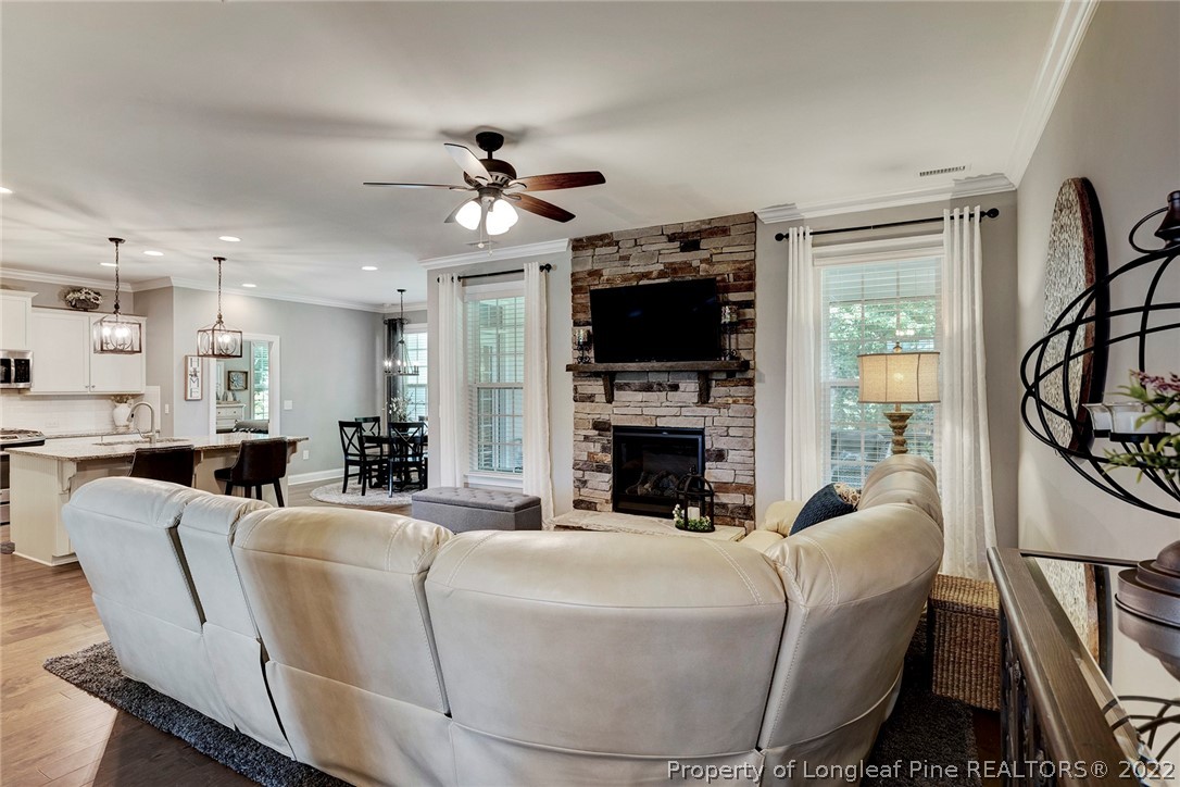 4139 Olde Judd Drive Willow Spring, NC 27592 - Photo 13 of 42 a living room with furniture a fireplace and a flat screen tv