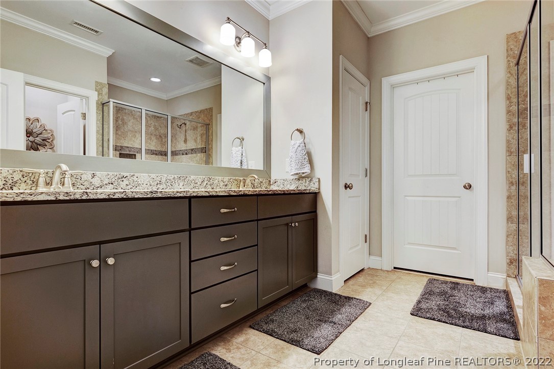 4139 Olde Judd Drive Willow Spring, NC 27592 - Photo 24 of 42 a bathroom with a granite countertop sink and a mirror