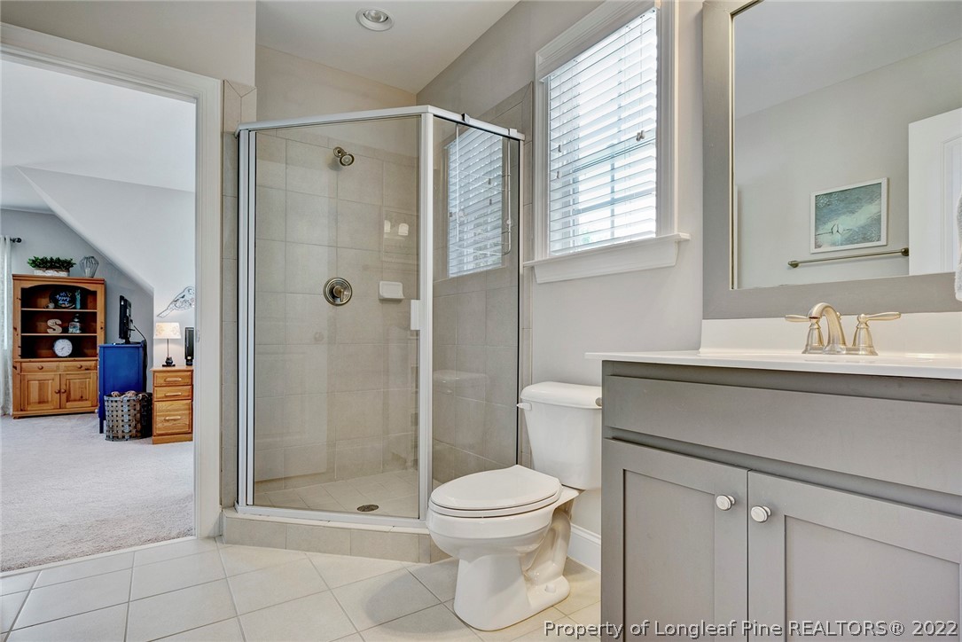 4139 Olde Judd Drive Willow Spring, NC 27592 - Photo 33 of 42 a bathroom with a shower sink vanity and toilet